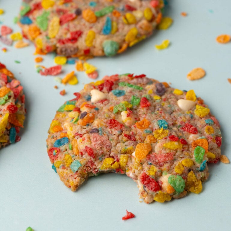 Fruity Pebbles cookies, with a bite taken out of the cookie front and center.