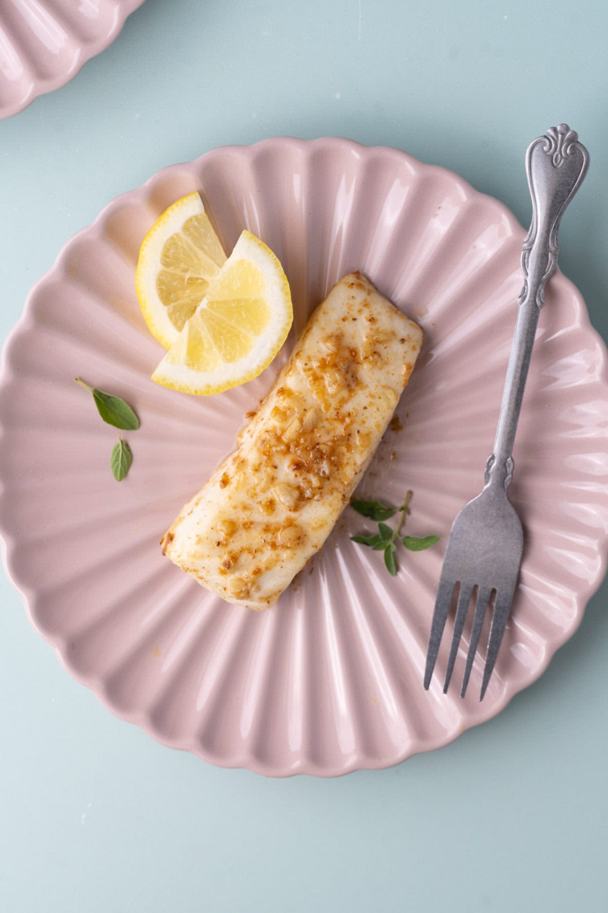 Overhead image of plated lemon butter halibut. 