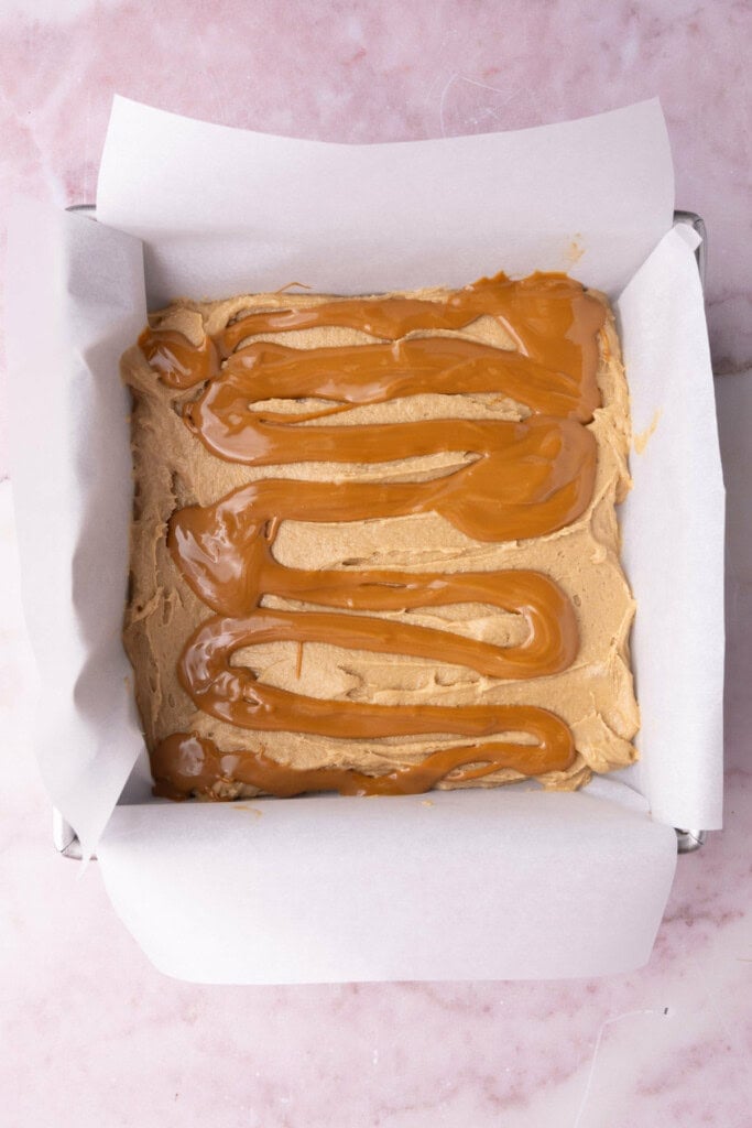 Blondie batter with cookie butter poured atop in swirls. 