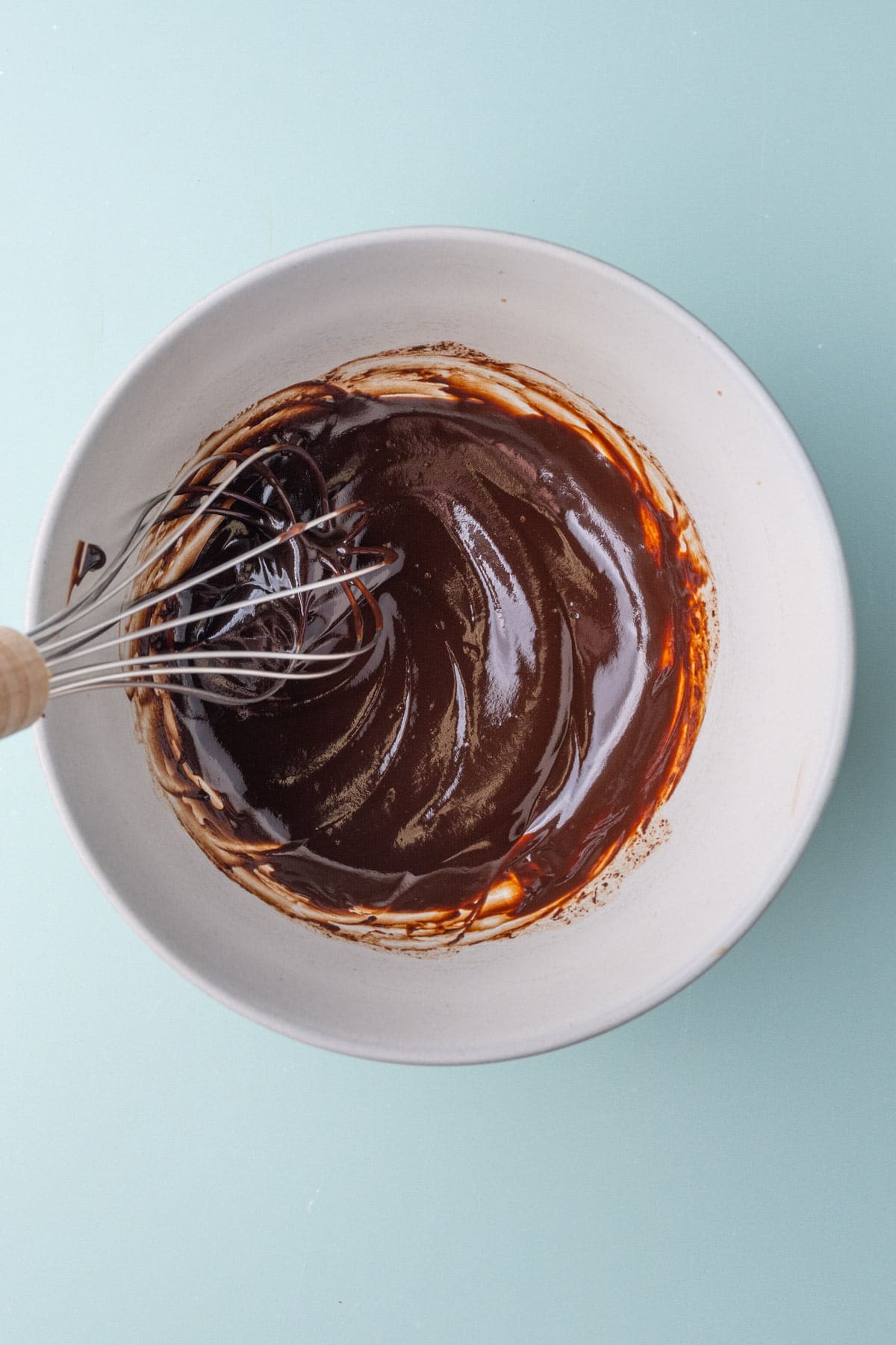 Melted chocolate fudge sauce made from chocolate chips, butter, and milk, whisked together after 30 seconds in the microwave.