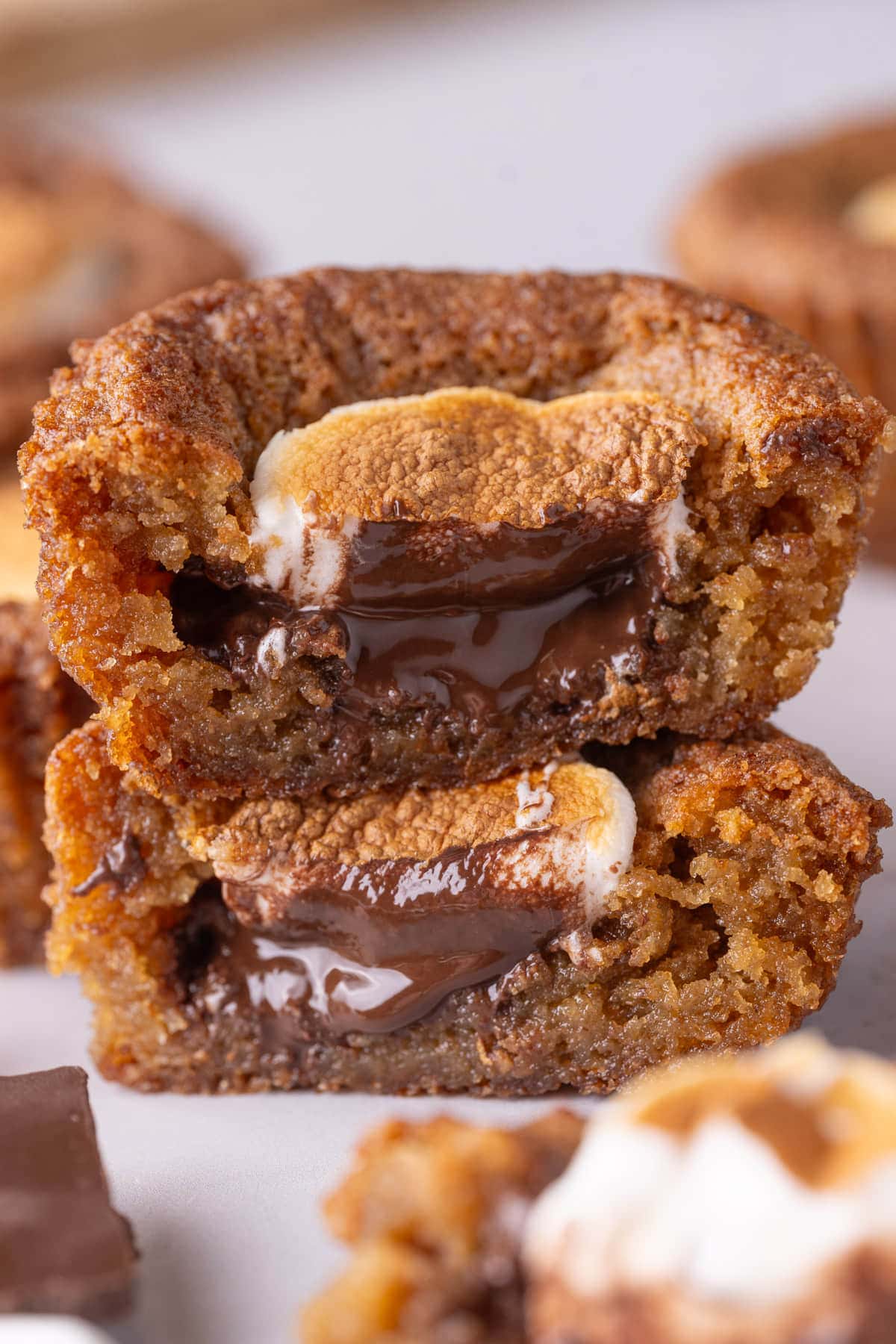 Close up of smores cookie cup cut in half and stacked atop each other.