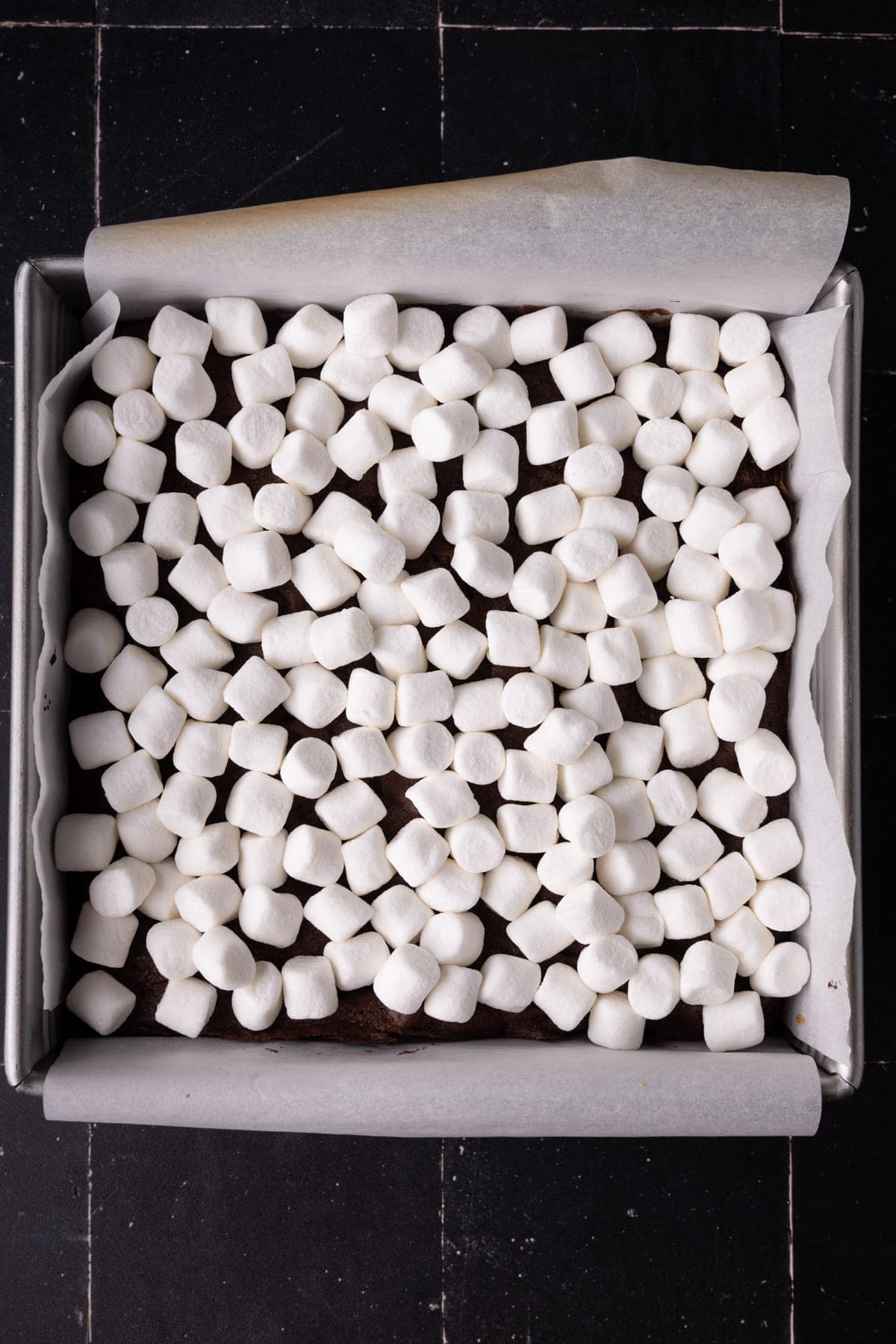 Adding mini marshmallows on top of almost-baked brownies before putting back in the oven.