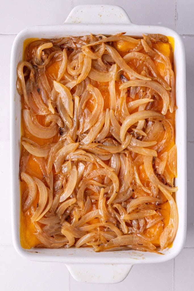 Caramelized onions piled on top of melted cheese on a Hawaiian roll.