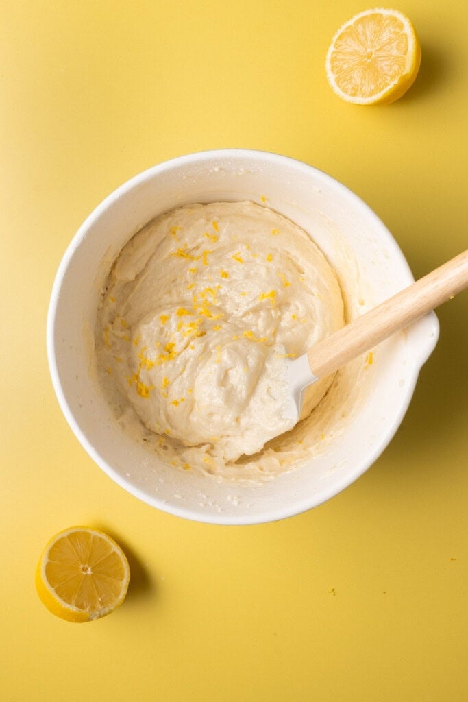 Folding lemon zest into light and airy cookie dough.