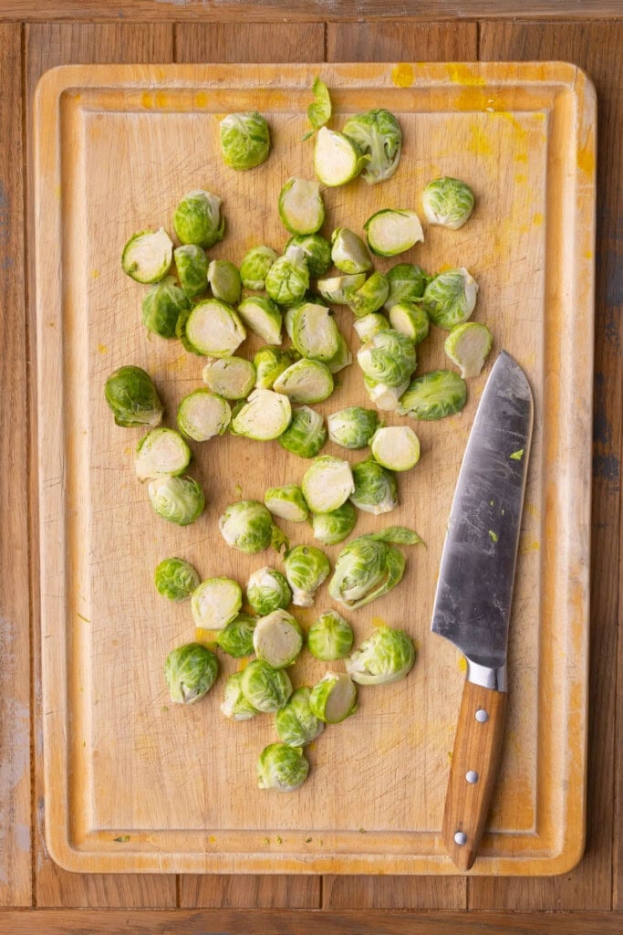 Fresh brussels sprouts halved with tips cut off.
