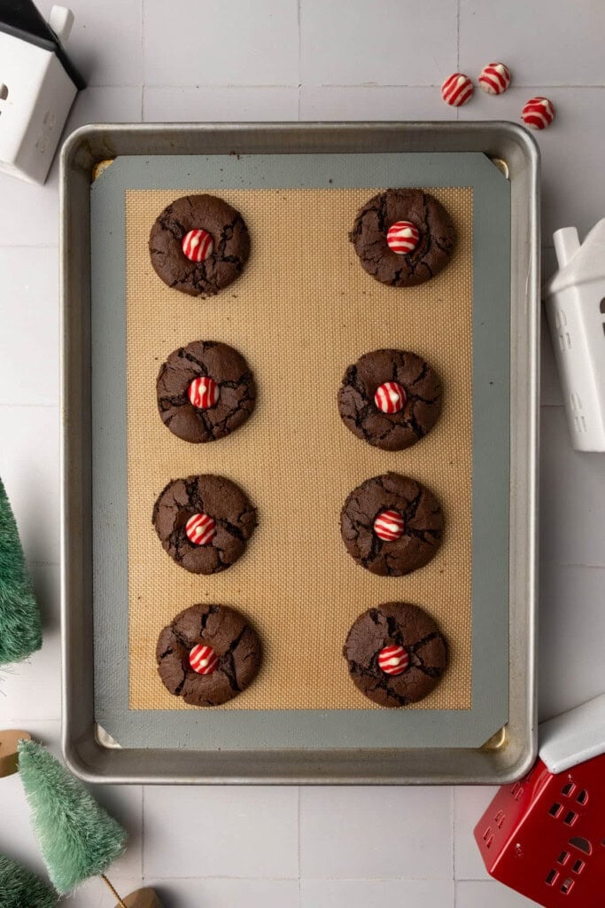 Still-hot chocolate cookies with peppermint kisses pressed into the center.