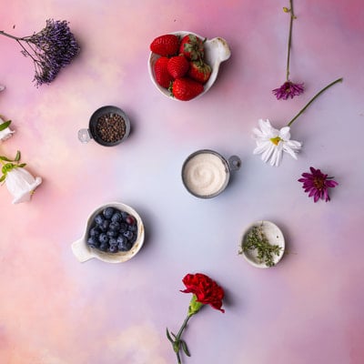 Overhead view of some baking ingredients and decorative flowers.