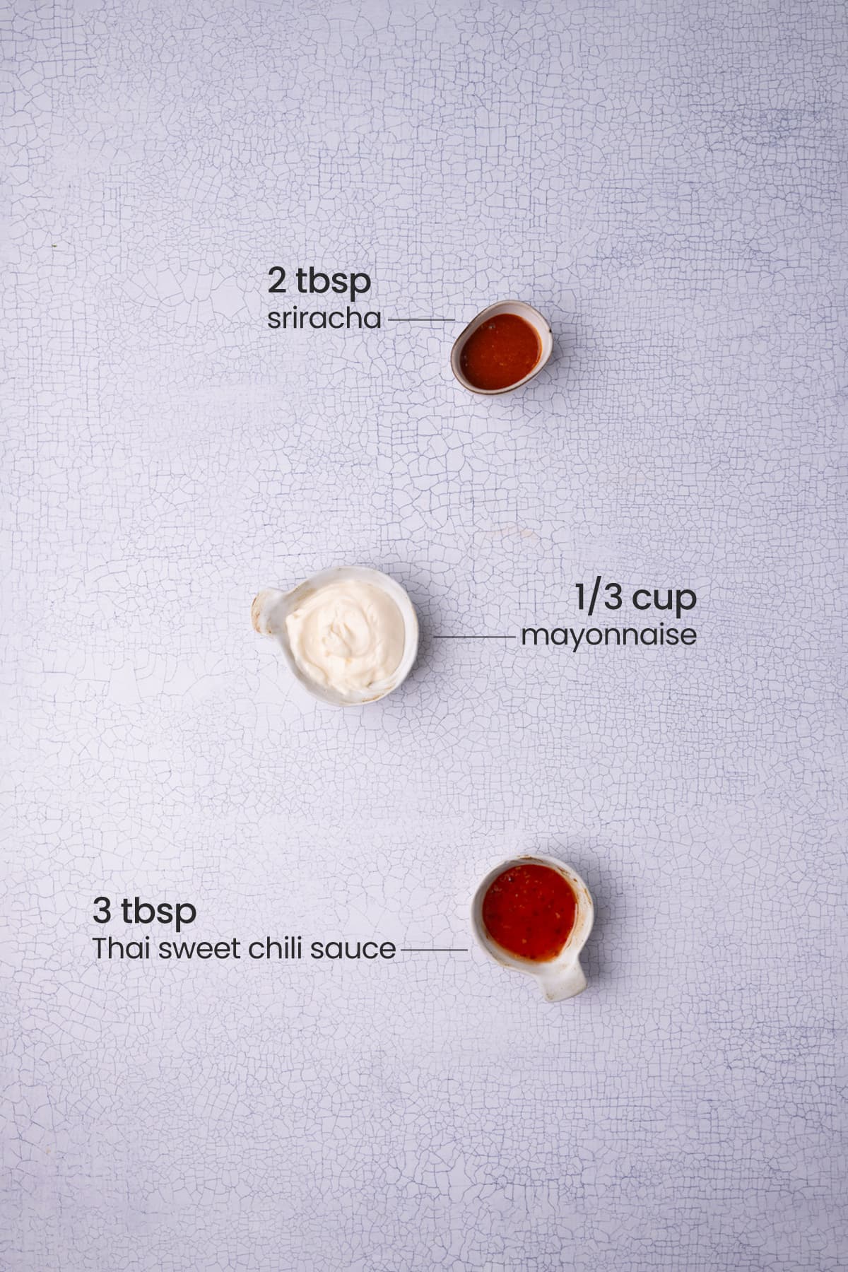 All ingredients needed for Bang Bang Sauce including mayonnaise, sweet Thai chili sauce, and Sriracha. 