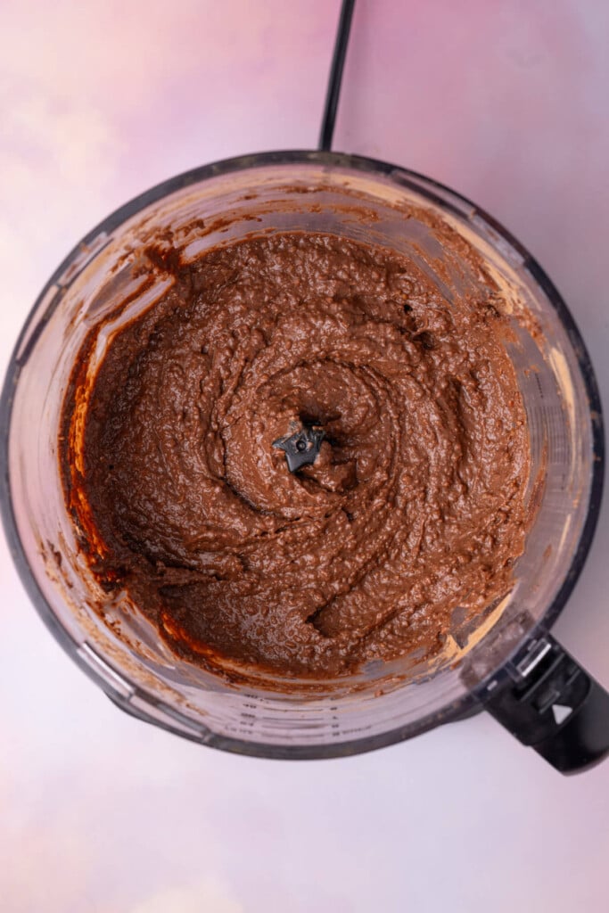 Brownie batter dessert hummus just blended in a food processor.