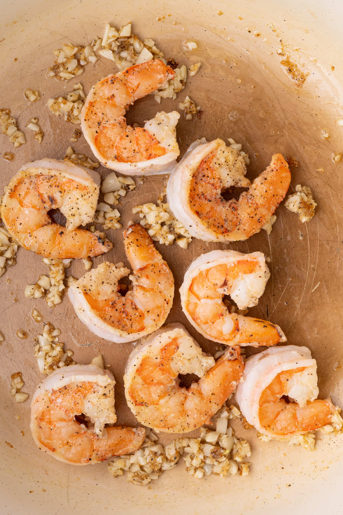 Shrimp and garlic cooking in olive oil in a pan. 