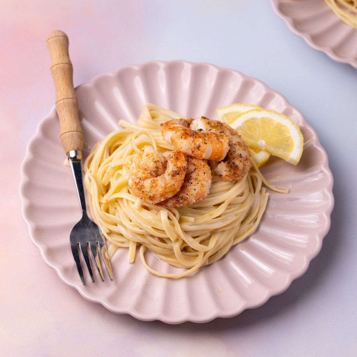 Shrimp pasta with creamy garlic sauce and lemon.