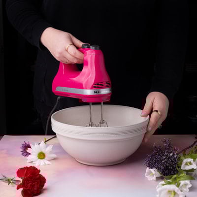 Whisking the contents of a mixing bowl.