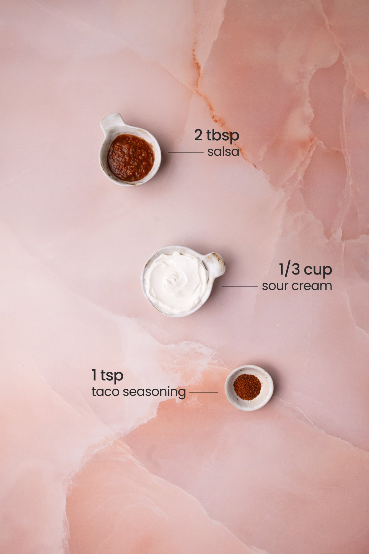 All the ingredients you need to make quesadilla sauce including sour cream, salsa, and taco seasoning. 