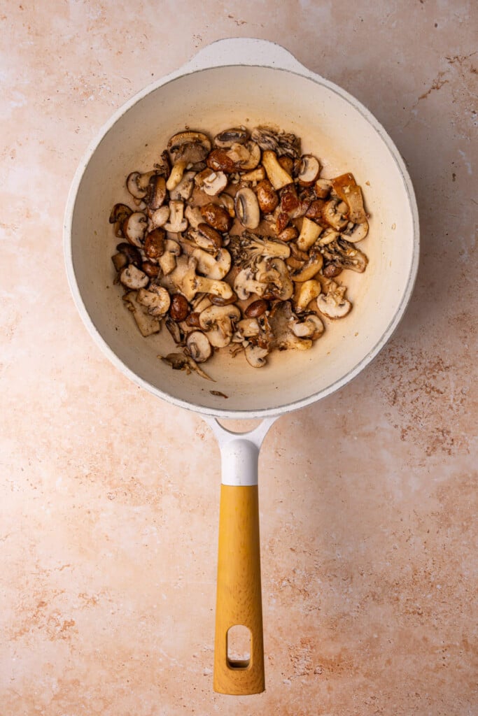 Cooking mushroom medley in olive oil, salt, pepper, and garlic.