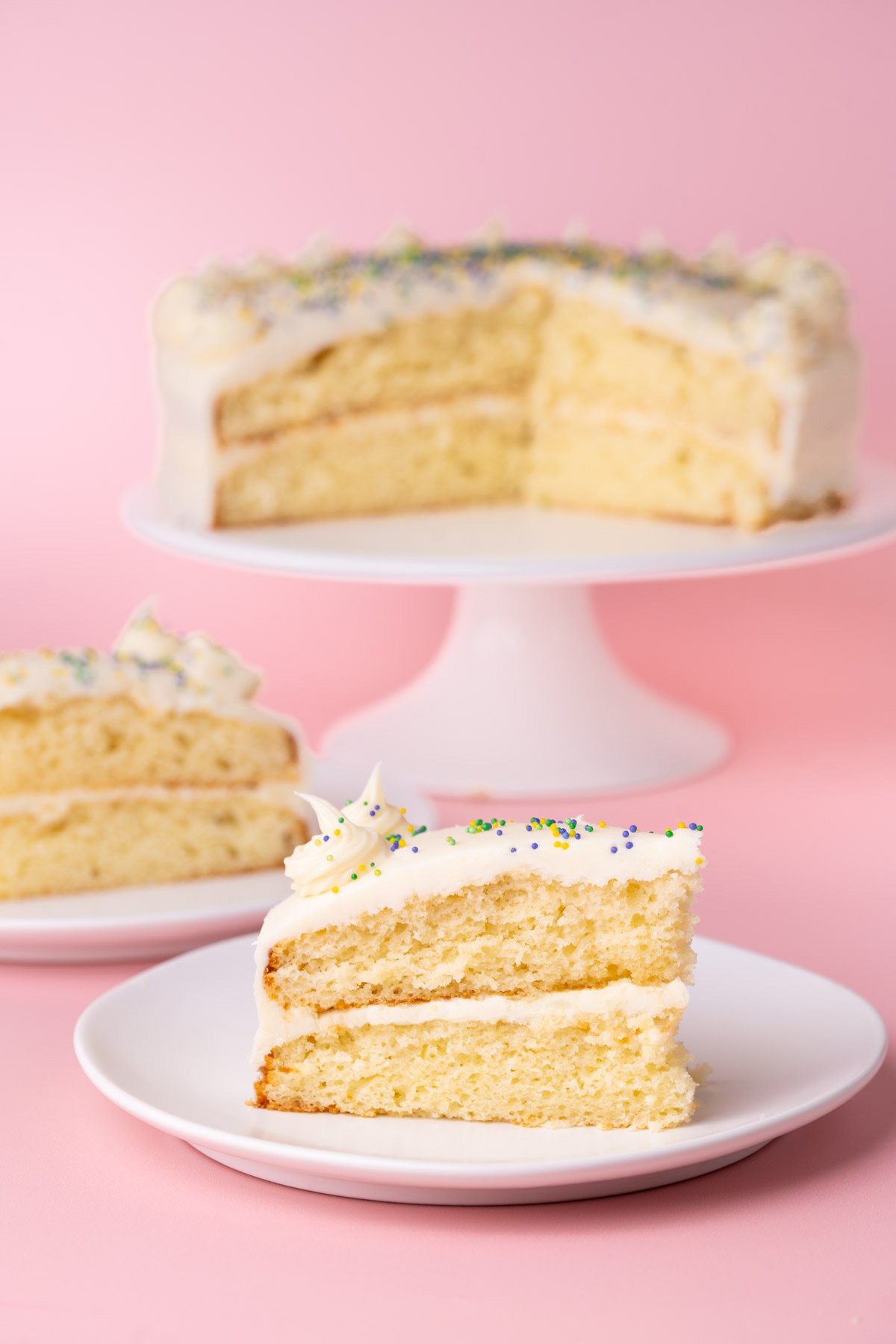 Elevated white cake with white chocolate ganache made from a mix using a hack. 
