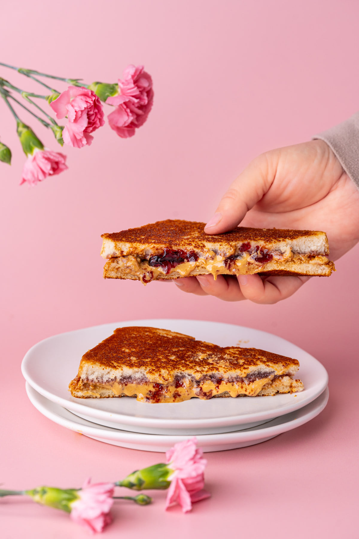 Grabbing one half of a PB&J to eat.