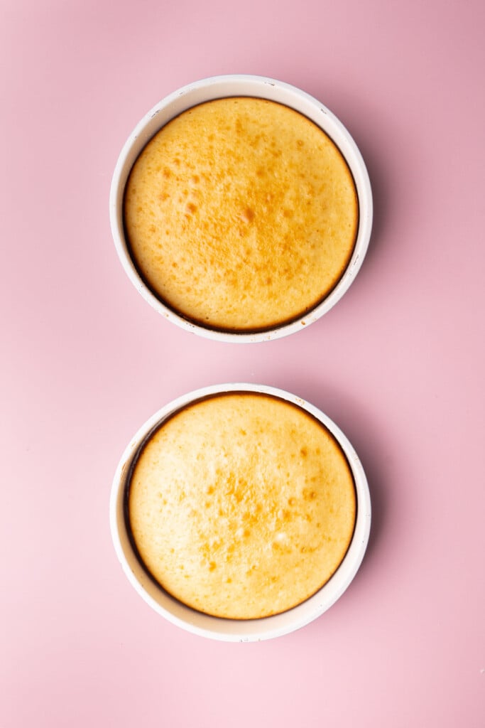 Two cakes fresh out of the oven, still in the pan, with a beautiful golden-brown top.