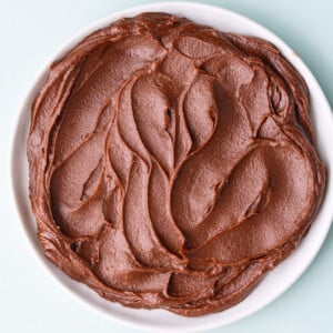 Close up of a small plate with swirls of milk chocolate ganache on it.