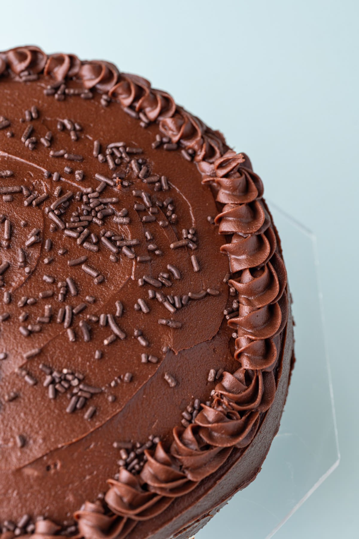 Close up of chocolate ganache piped onto a cake.