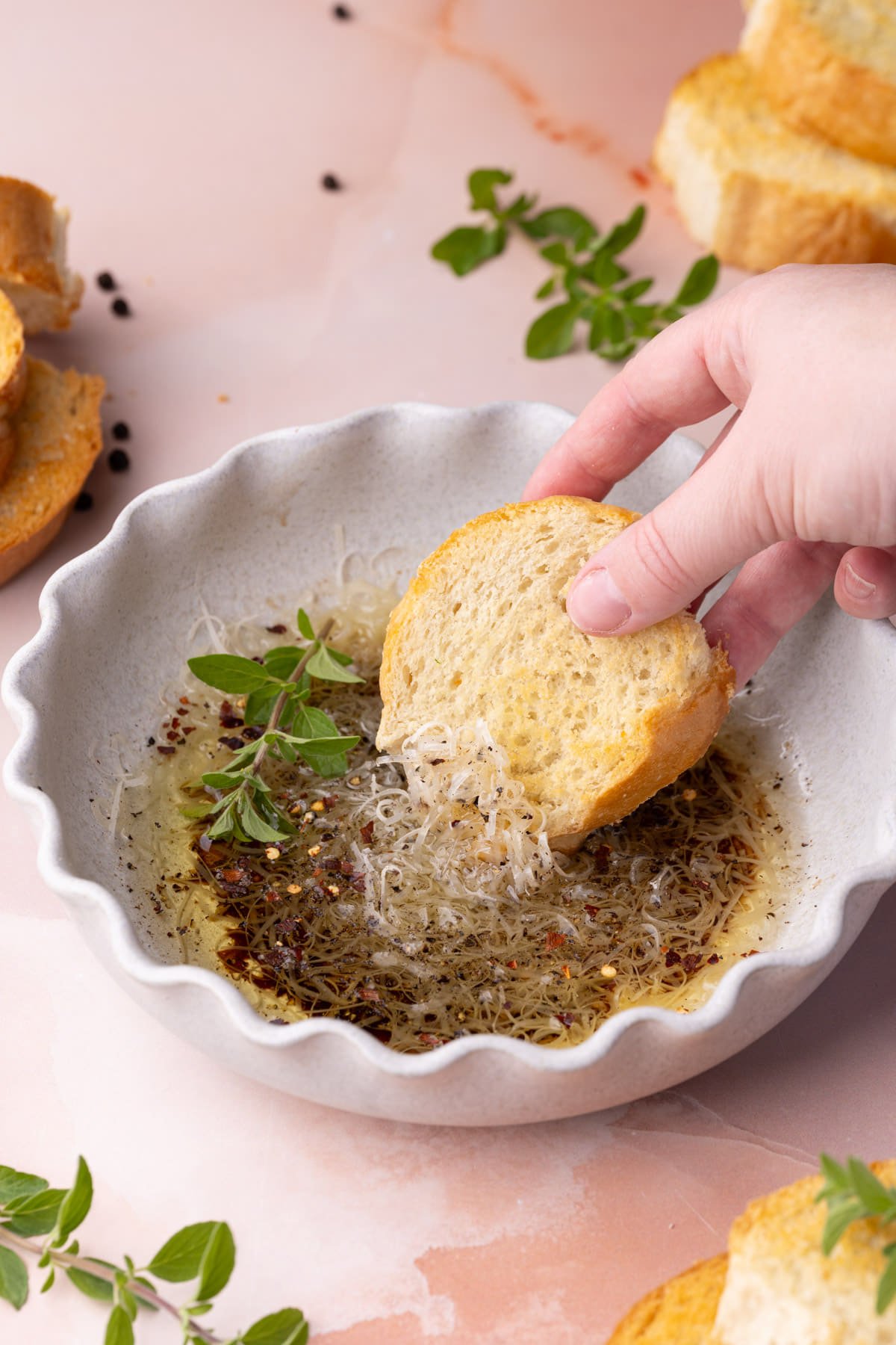 Dipping bread into olive oil and balsamic vinegar sauce. 