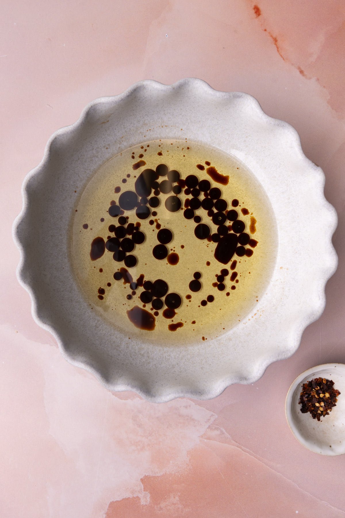Balsamic vinegar drizzled into olive oil to make a dip for bread. 