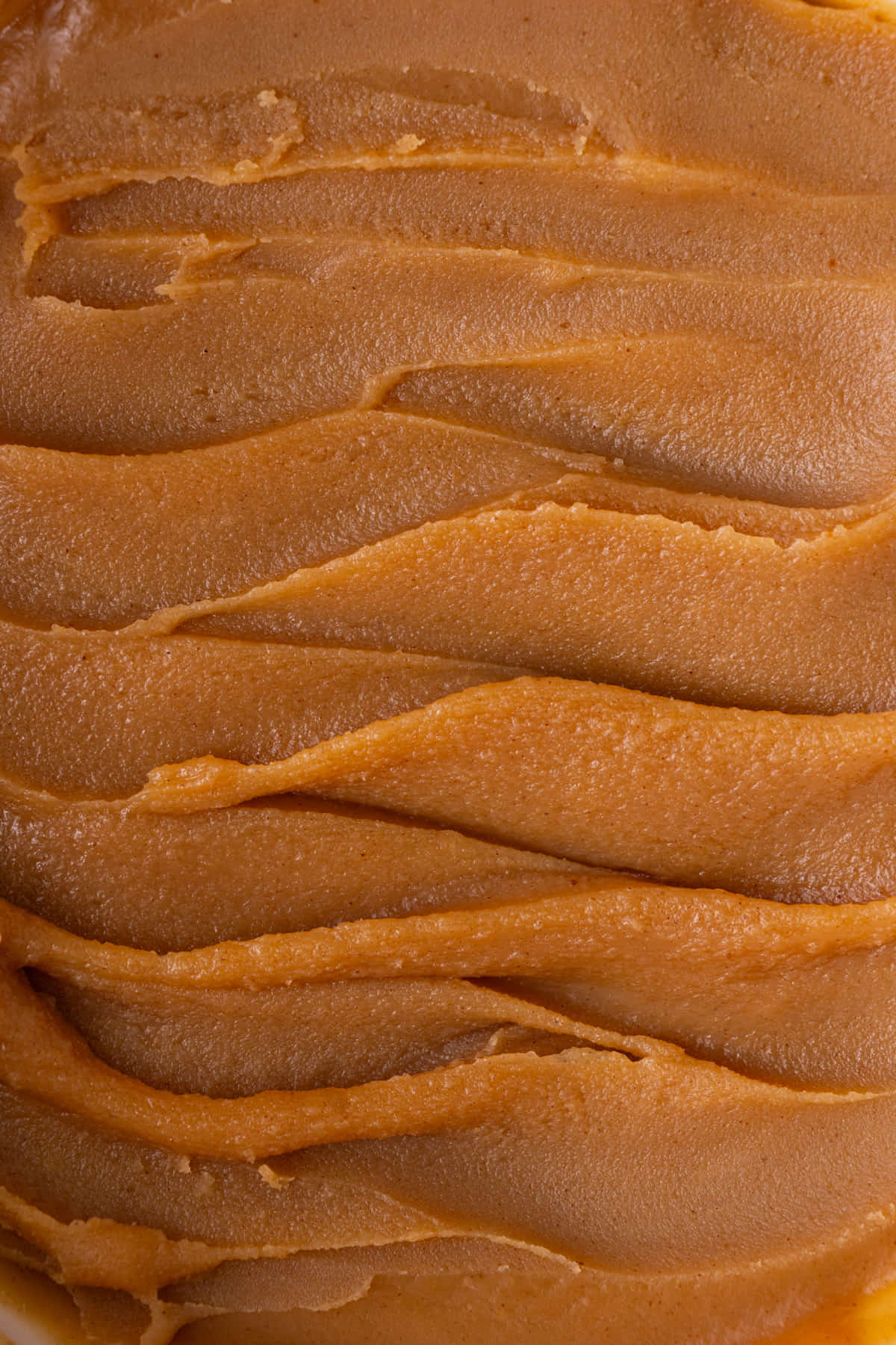 Close up of peanut butter ganache with swirls in it made from a spatula.