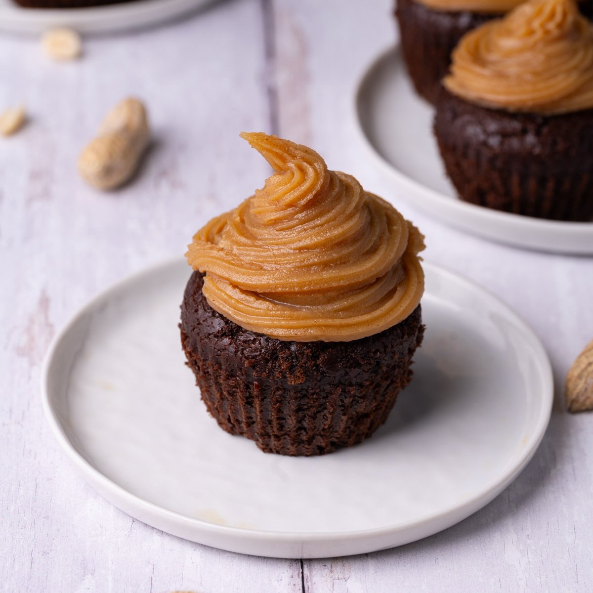 Close up of chocolate cupcake with piped on peanut butter ganache.