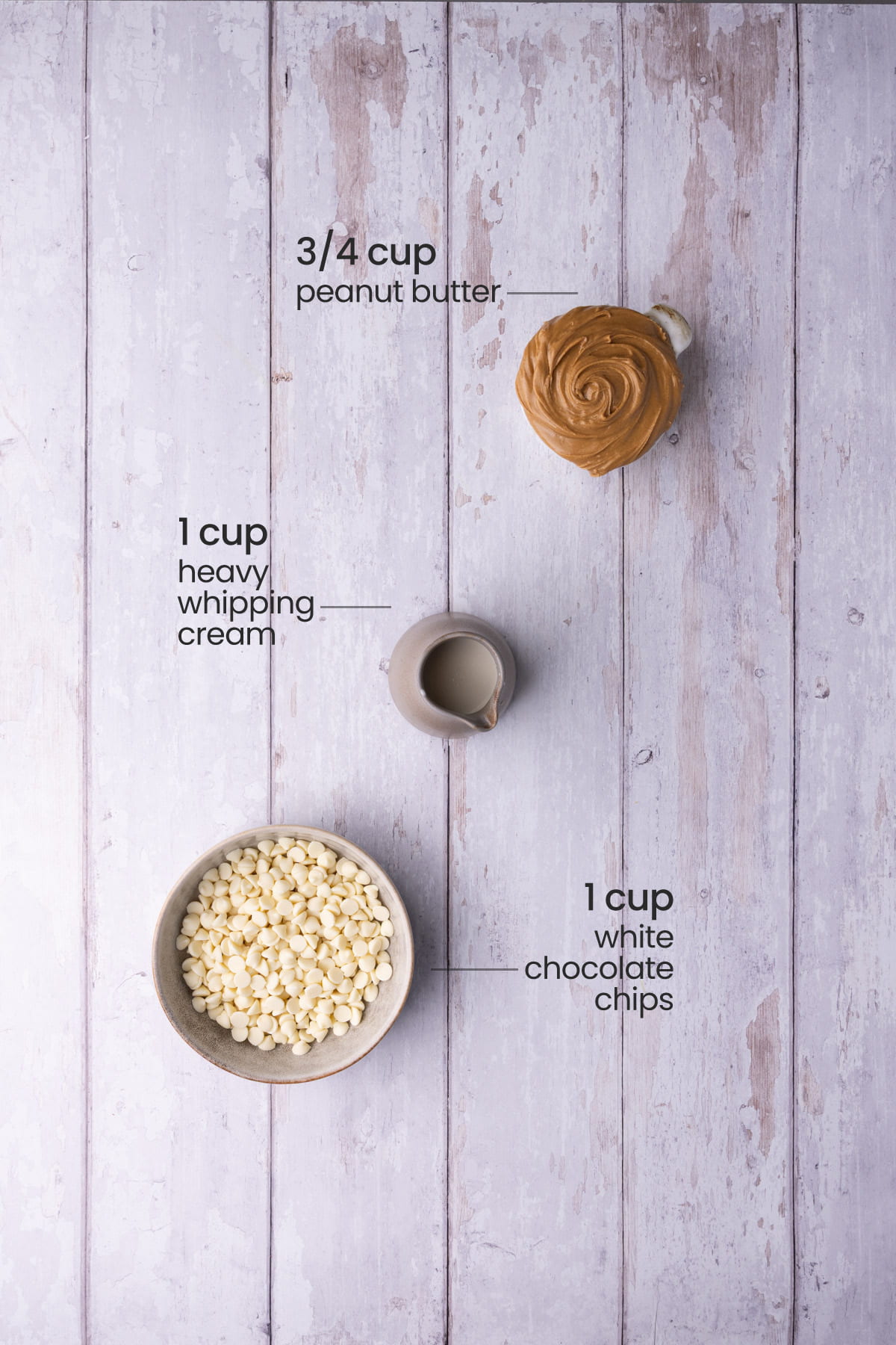 Overhead view of the ingredients for peanut butter ganache - peanut butter, heavy whipping cream, and white chocolate chips.