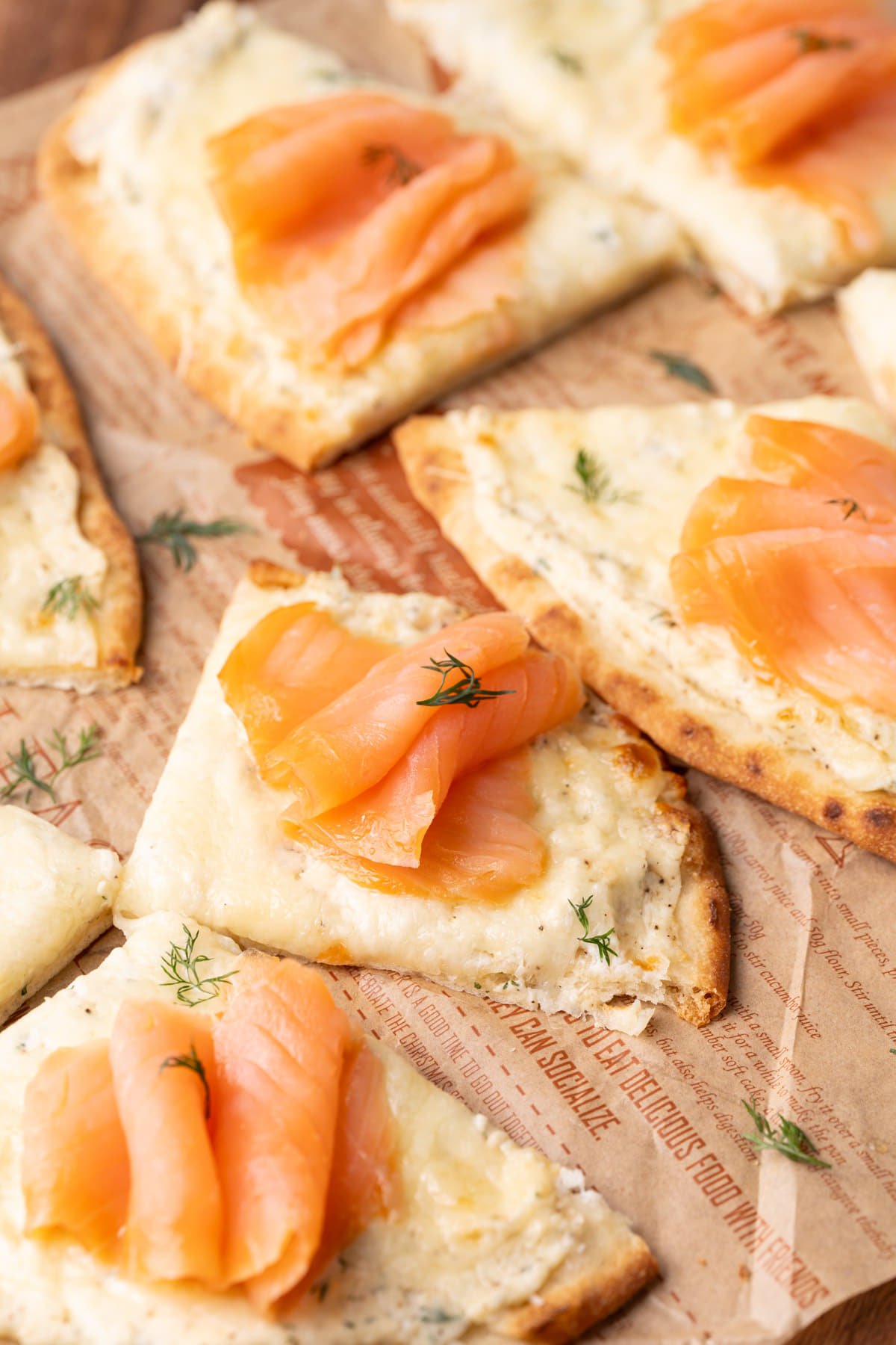Naan flatbread with smoked salmon and dill, sliced into 4 pieces. 