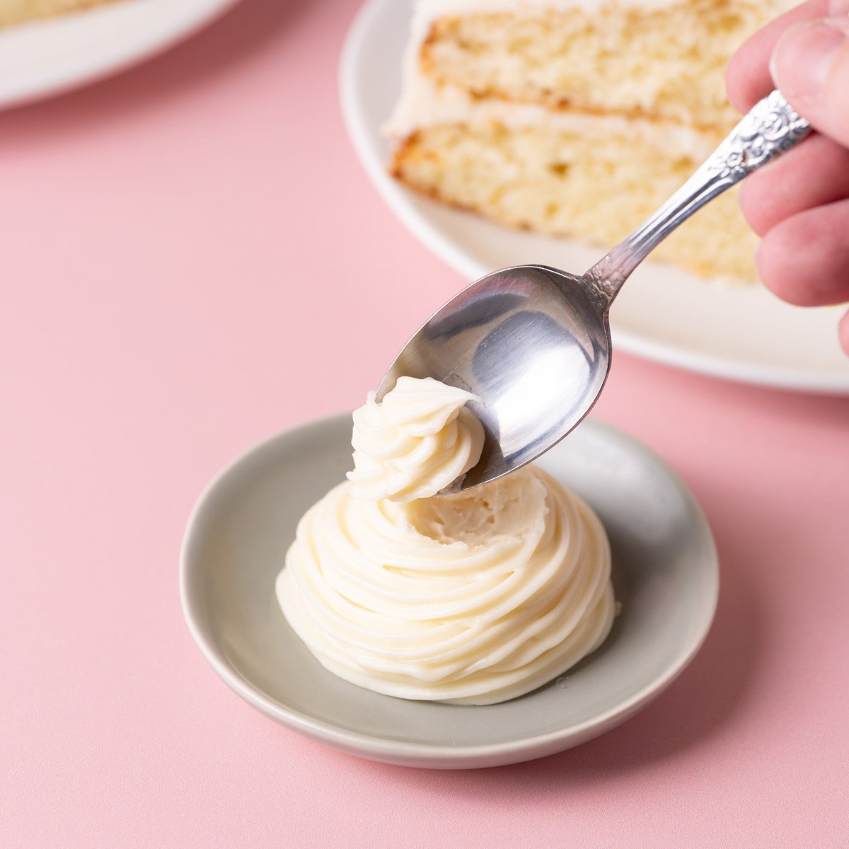 Thick, spreadable white chocolate ganache on a spoon.