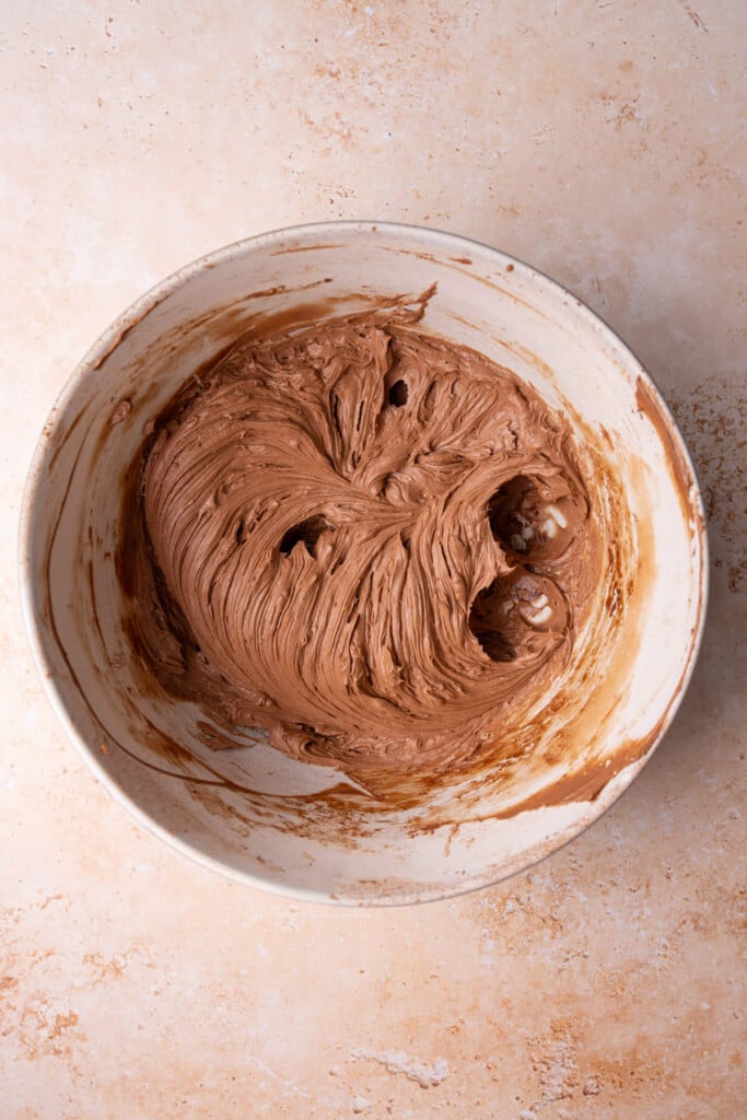 Chocolate frosting with cream cheese whipped in a large mixing bowl. 