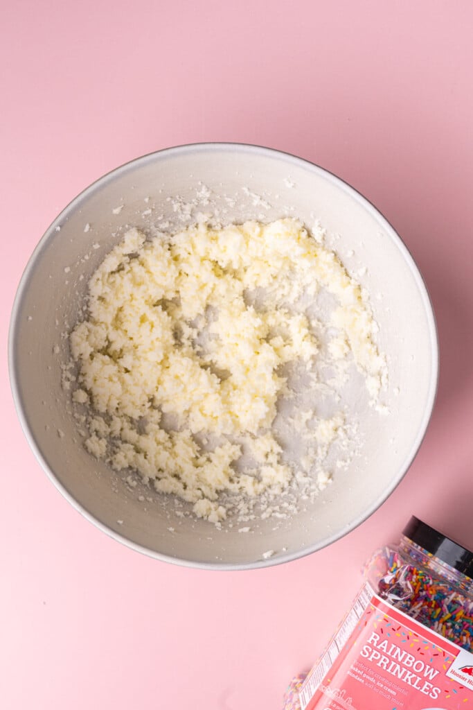 Granulated sugar and softened unsalted butter creamed together in a large mixing bowl.