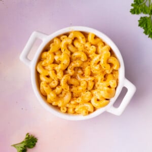 Small cocotte filled with Cajun Mac and Cheese on colorful background.