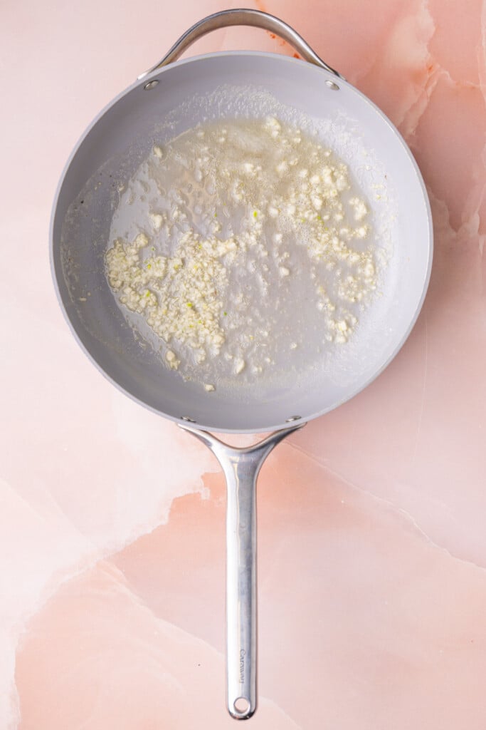 Minced garlic cooking in unsalted butter. 