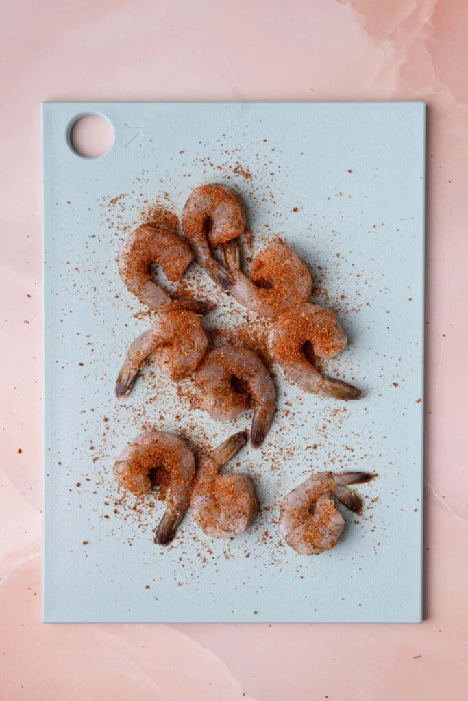 Shrimp generously seasoned on both sides with Cajun seasoning. 