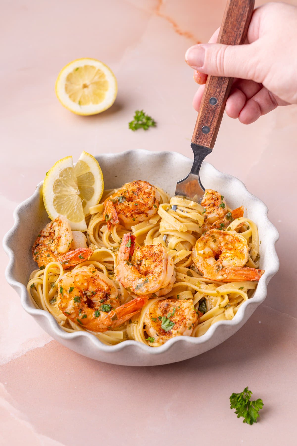 Twirling pasta with Cajun shrimp scampi on a fork.