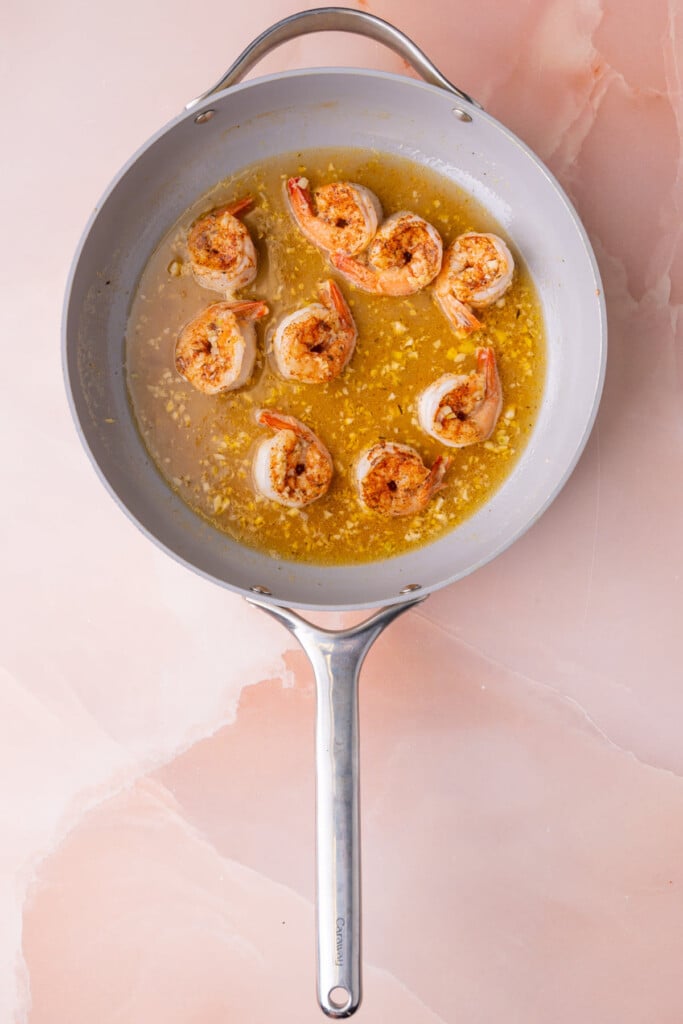 Shrimp simmering in white wine and lemon juice.
