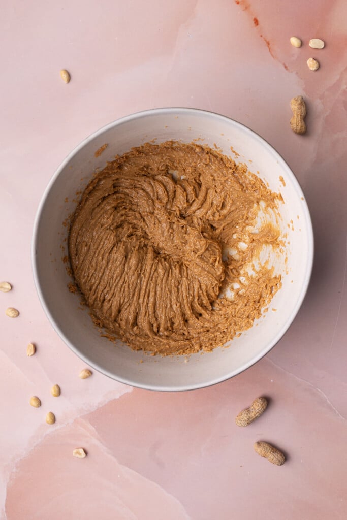 Butter, creamy peanut butter, and brown sugar creamed together in a large mixing bowl. 