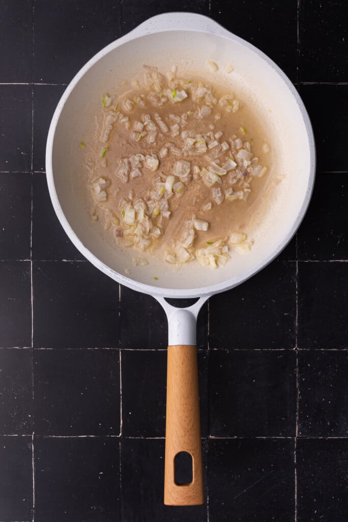 Cooking shallots in butter until soft and fragrant.