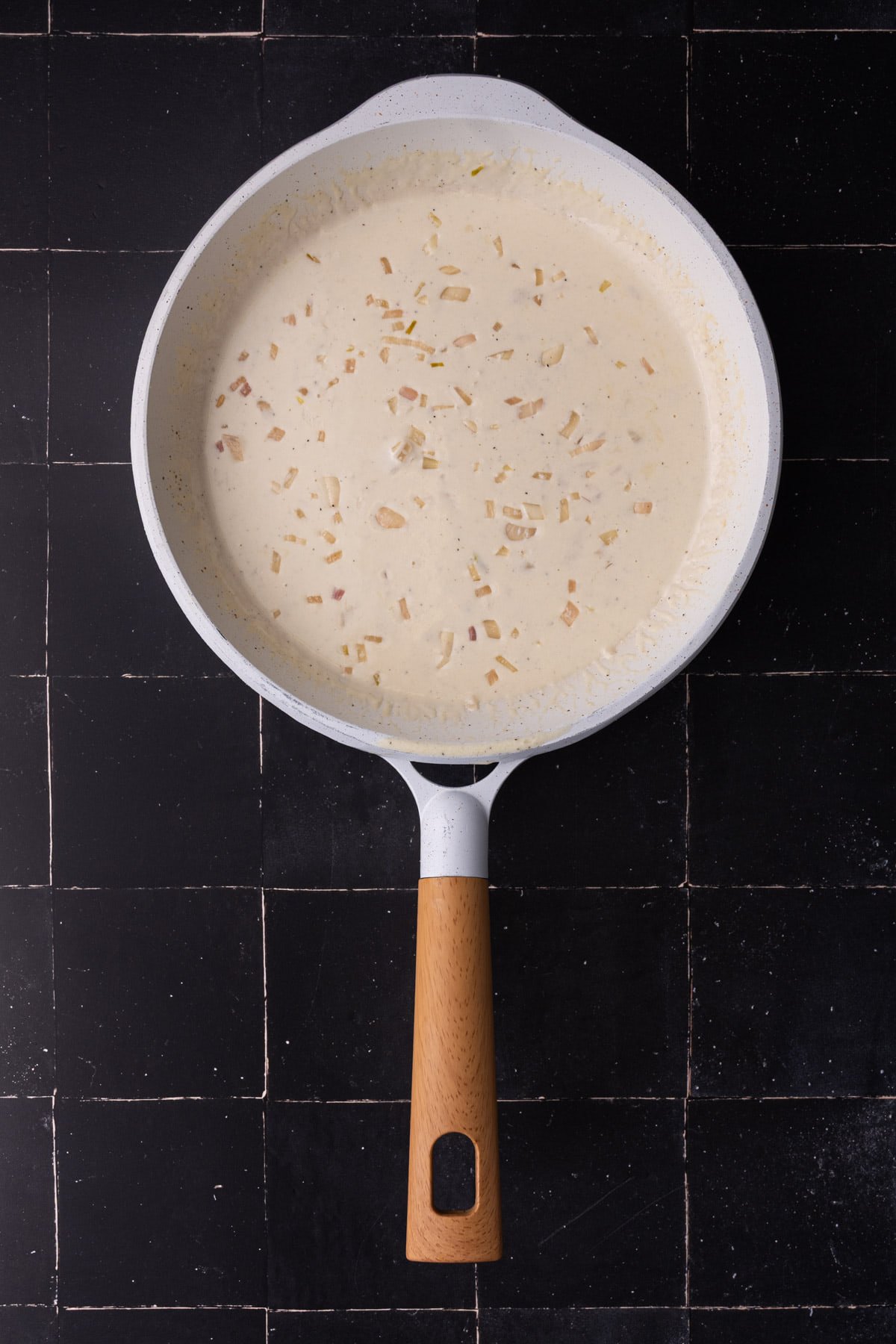 Sherry cream sauce thickening in pan.