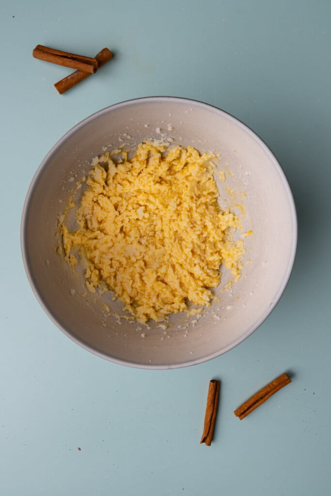 Creamed butter and sugar in a large mixing bowl with an egg and vanilla extract just mixed in. 