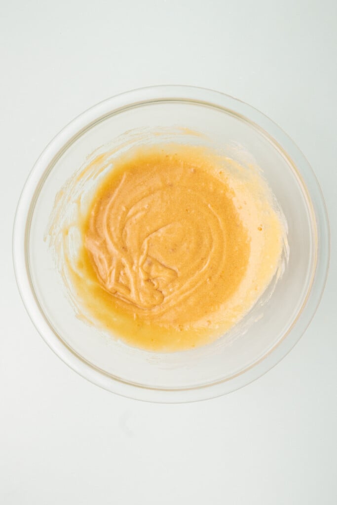 Butter, sugar, egg and vanilla extract whisked together in a glass bowl. 