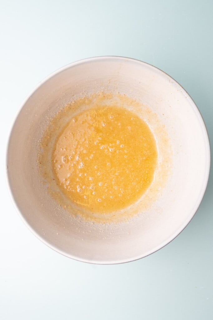 Melted, browned butter creamed with granulated sugar in a large mixing bowl.
