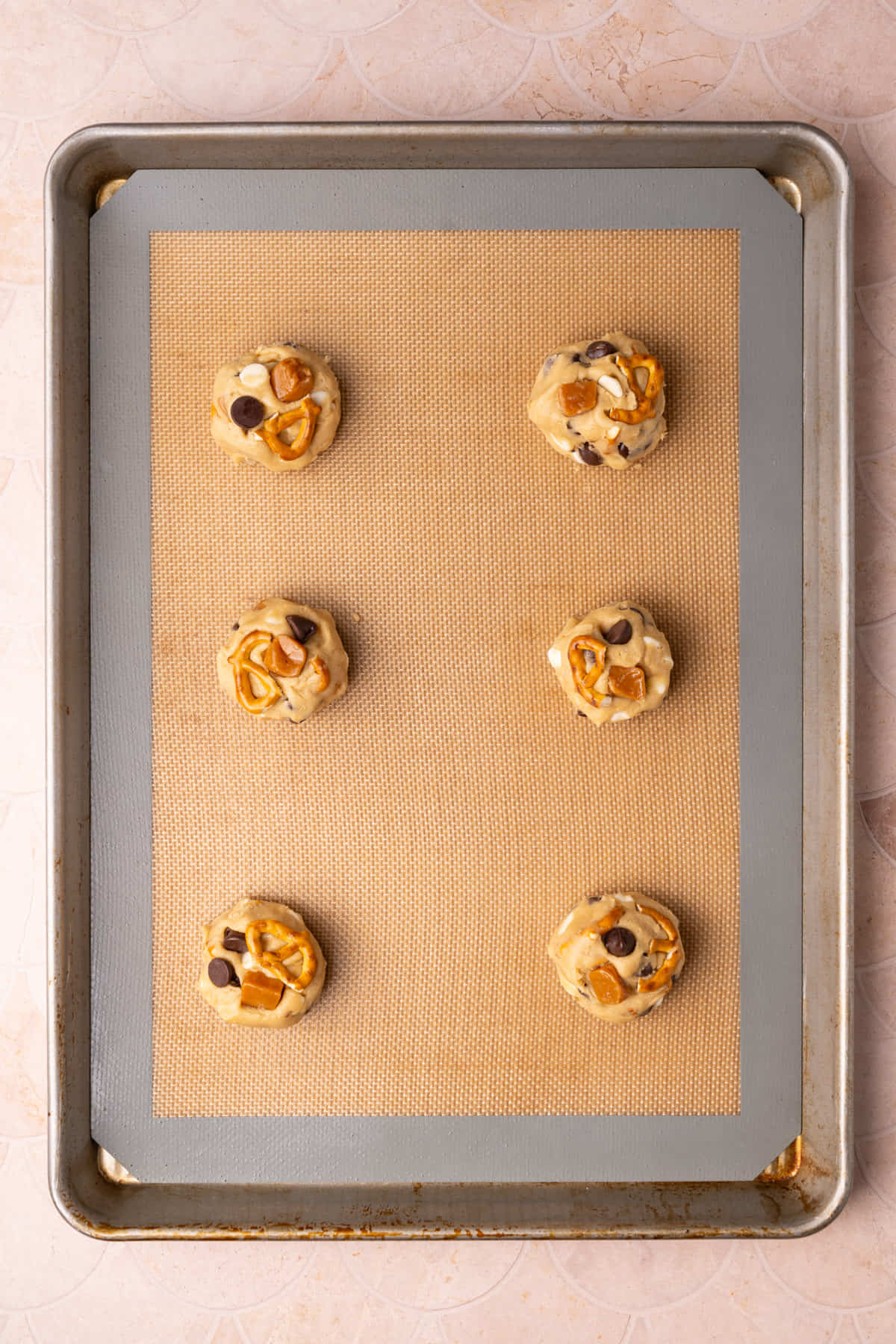 Kitchen sink cookie dough on a lined baking sheet ready to bake. 