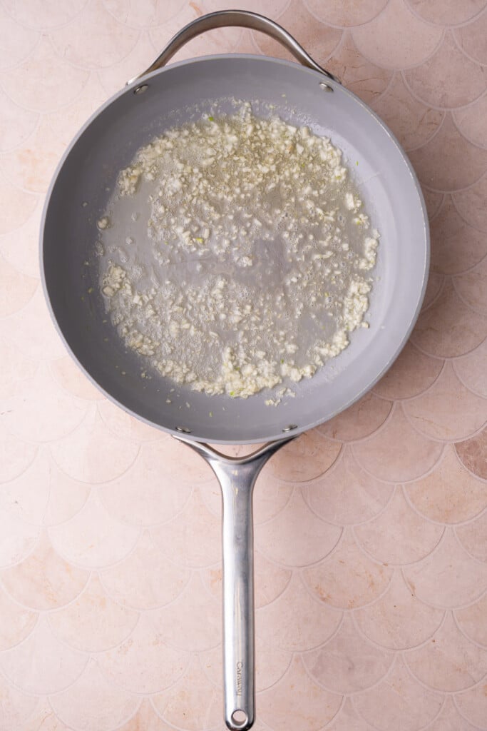 Cooking garlic in butter in a pan over medium heat. 