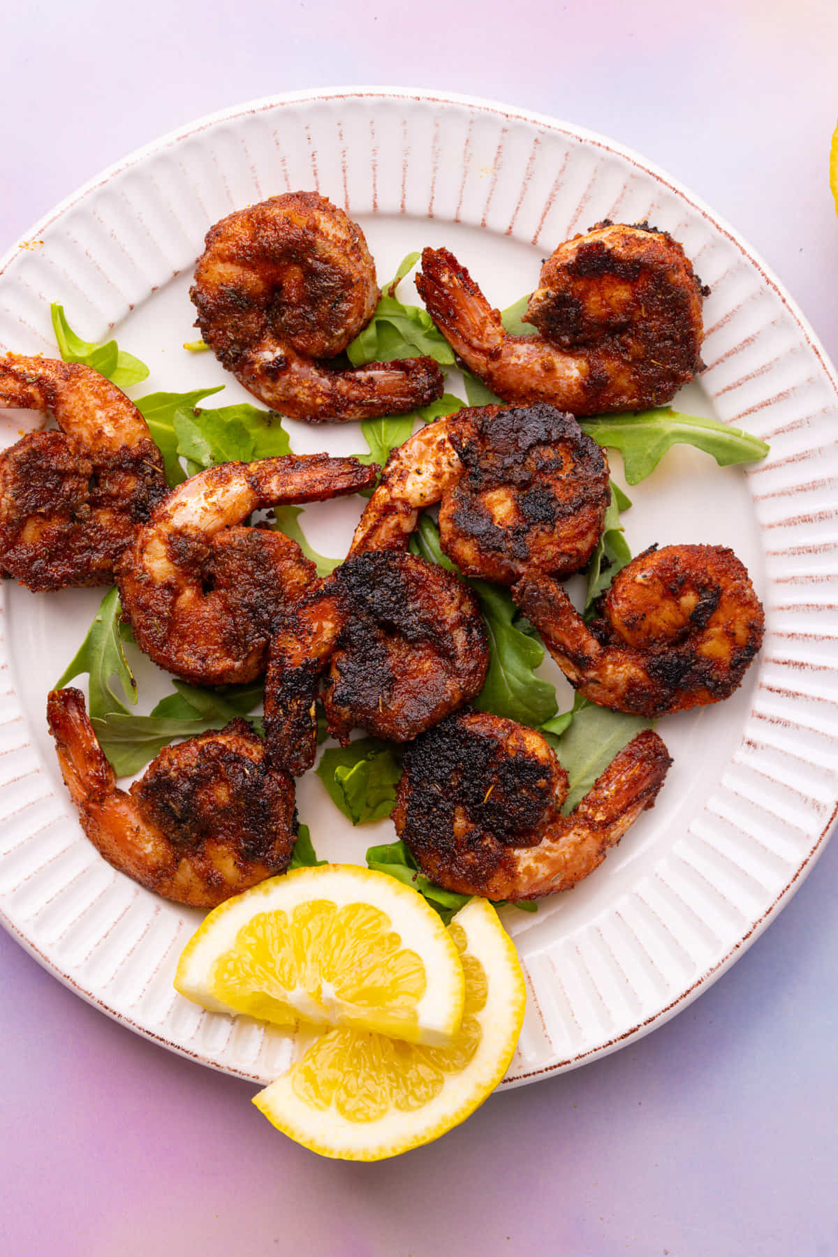 Overhead image of a plate with a crispy blackened crust.