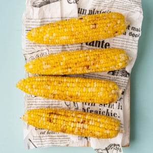 Overhead image of Cajun corn on the cob that's been roasted in the oven.