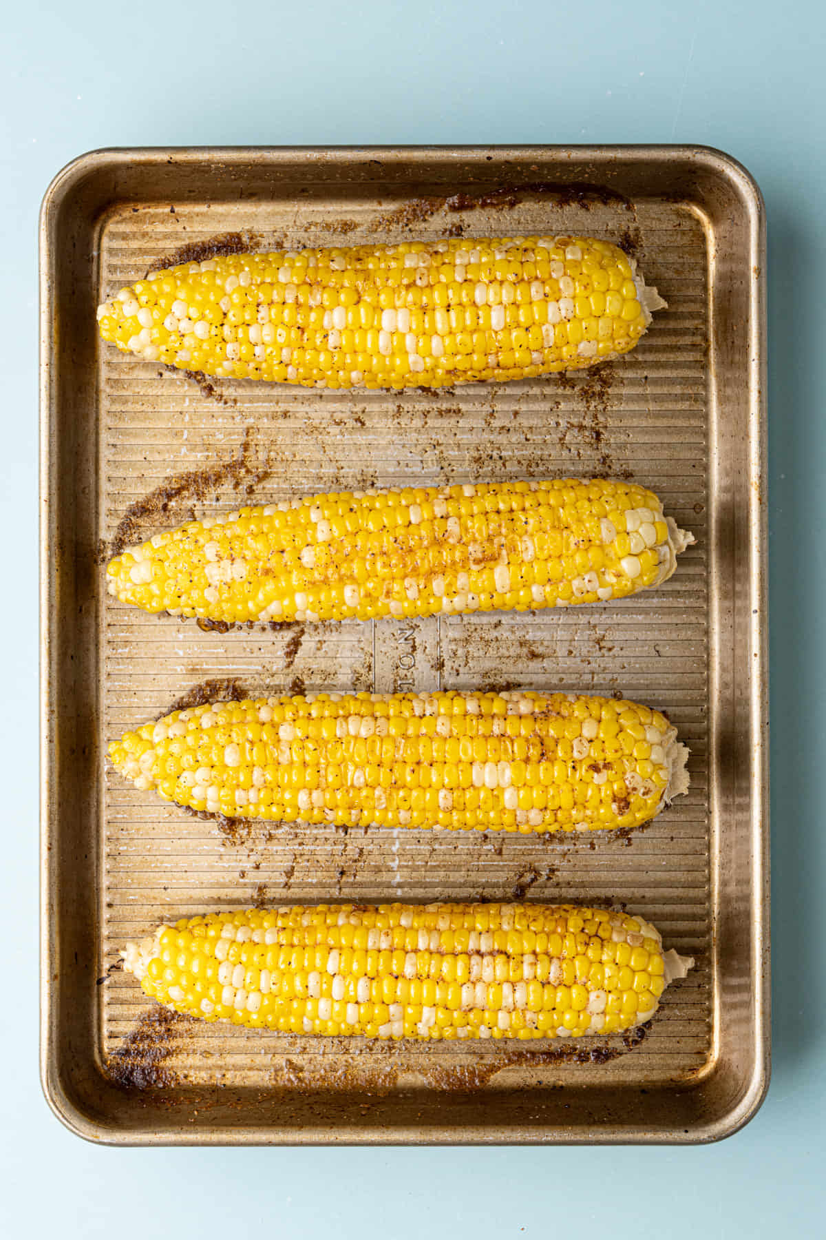 Cajun Roasted Corn on the Cob fresh out of the oven still on the baking tray.