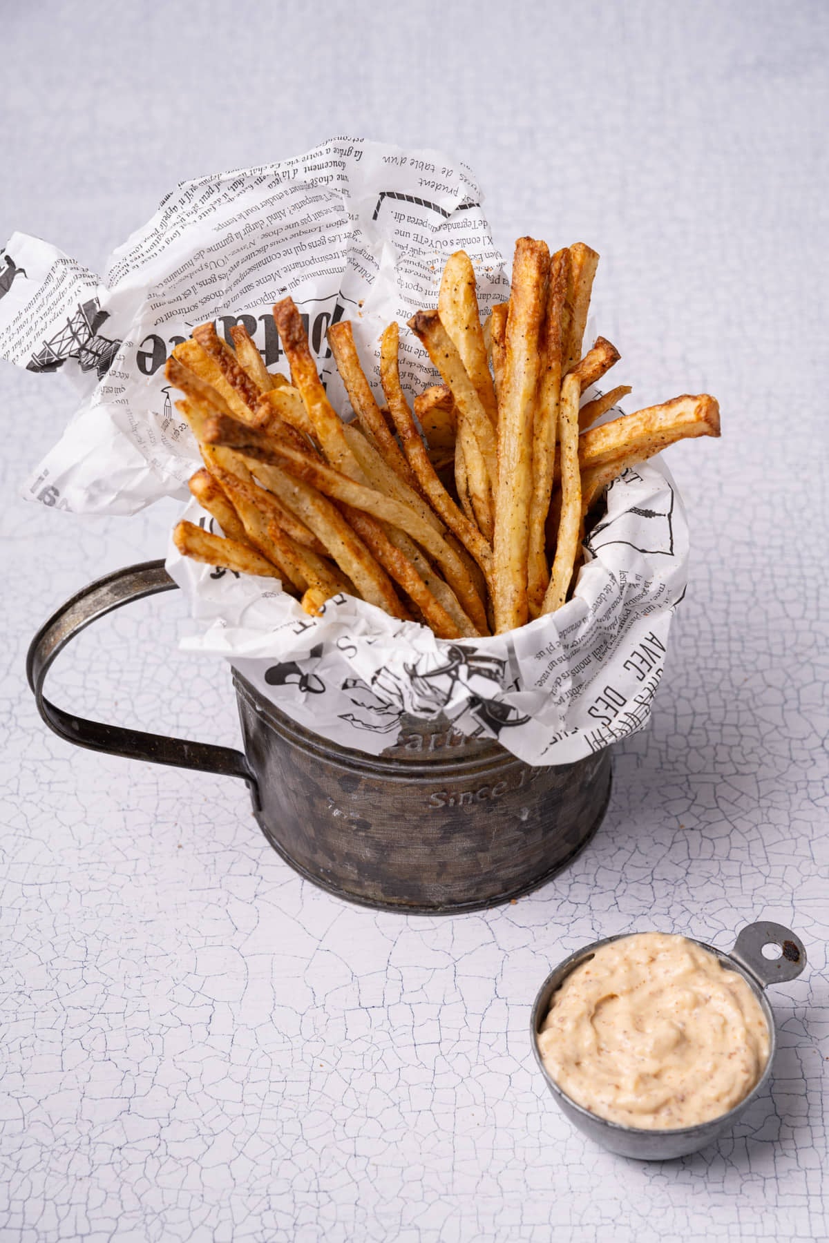 Bucket of homemade Cajun fries served up with a creamy Cajun remoulade.