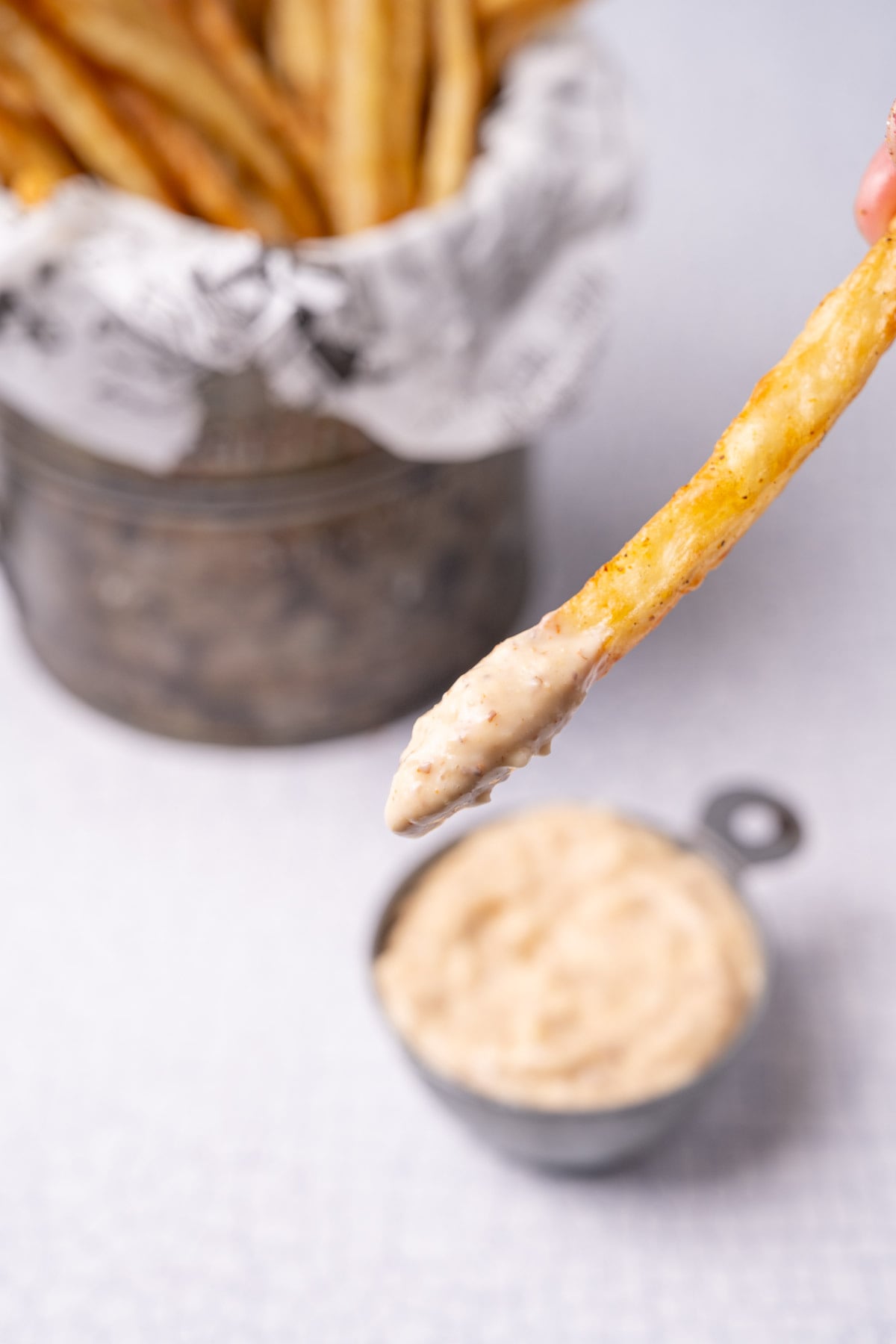 Close up of Cajun remoulade on a French fry.